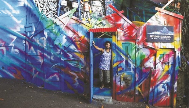 Artist Wilson Alexandre poses at the entrance of his house and art studio in the Vidigal favela of Rio de Janeiro.