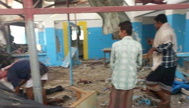 A picture released by Doctors Without Borders shows people examining a hospital operated by the NGO after it was hit by an Arab coalition air strike in Abs on Monday.