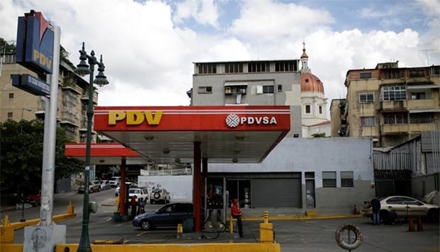 Venezuela is on track for its steepest annual oil output drop in 14 years. Pictured is a gas station of state oil company PDVSA in Caracas.