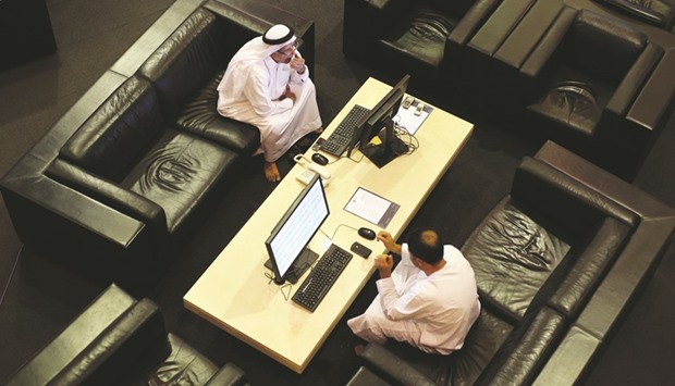 Visitors look at financial information on computer screens at the Dubai Financial Market. DFM, the Gulfu2019s only listed exchange,  gained 3.8% yesterday in its heaviest trade since May 3.