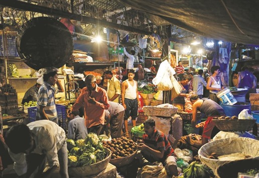 Vendors work at a wholesale vegetable market in Mumbai. Indiau2019s annual rate of inflation based on wholesale prices shot up to 3.55% for July from 1.62% in the previous month, due to an 11.82% jump in prices of food articles, official data showed yesterday.