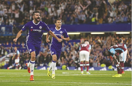 Chelseau2019s Brazilian-born Spanish striker Diego Costa (left) celebrates after scoring against West Ham United in their Premier League opener in London on Monday. (AFP)