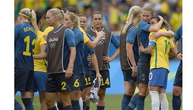 Brazilu2019s player Marta (R) is comforted by a Swedish player after Brazil lost in their Rio 2016 Olympic Games Womenu2019s semi-final football match at the Maracana Stadium in Rio.