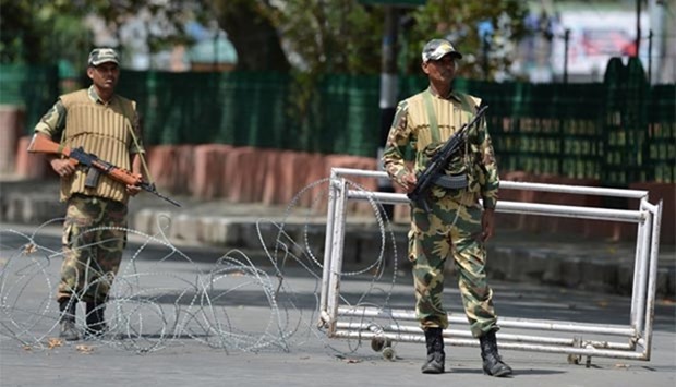 Indian paramilitary troopers stand guard during a curfew in Srinagar on Wednesday.