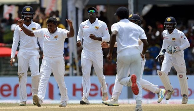 Sri Lanka's Rangana Herath (second left) celebrates with teammates after he dismissed Australia's Adam Voges during the final day of the final Test at the Sinhalese Sports Club ground in Colombo on Wednesday.