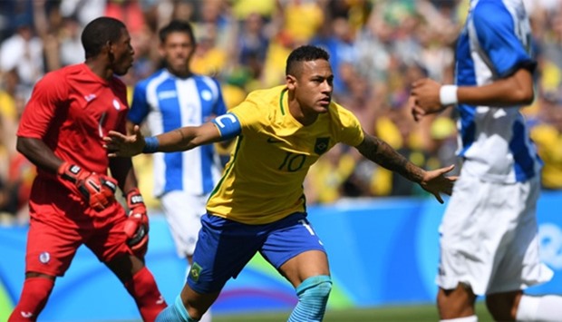 Brazil's Neymar (C) celebrates after scoring against Honduras