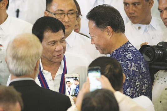 Philippine President Rodrigo Duterte talks with Chinese ambassador to the Philippines Zhao Jianhua (right) during the 115th Police Service Anniversary at the Philippine National Police (PNP) headquarters in Quezon city, metro Manila, yesterday.