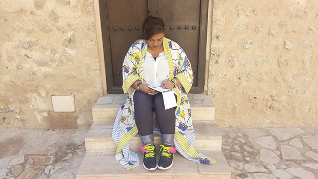 BETWEEN THE LINES: Afra Atiq penning a poem. Atiq prefers to lose herself in rhymes when she isnu2019t busy studying for her PhD in Mass Communication at UAE University.
