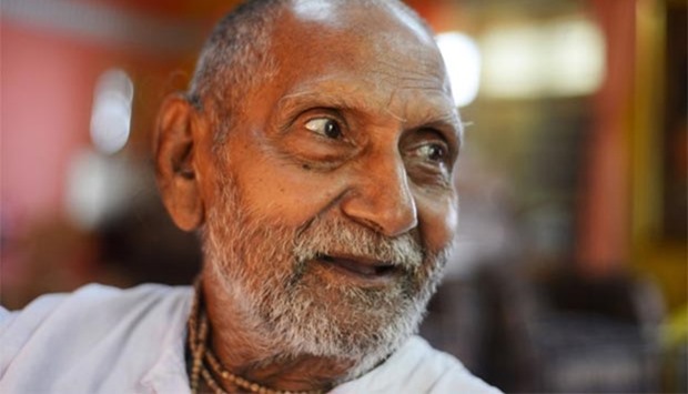 Indian monk Swami Sivananda, who claims to be 120 years old, smiles ahead of performing his morning stretches and yoga in Kolkata.