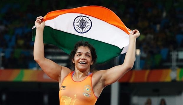 India's Sakshi Malik celebrates after winning a bronze medal, beating Kyrghyzstan's Aisuluu Tynybekova in their women's 58kg freestyle match at the Rio Olympics.
