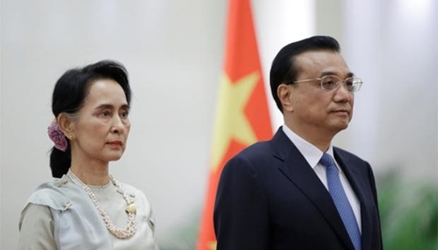 China's Premier Li Keqiang and Myanmar State Counsellor Aung San Suu Kyi attend a welcoming ceremony in Beijing on Thursday.
