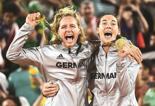 Germanyu2019s Laura Ludwig (left) and Kira Walkenhorst celebrate on the podium after taking the womenu2019s beach volleyball gold. They beat Brazil 21-18, 21-14 in the final. (AFP)