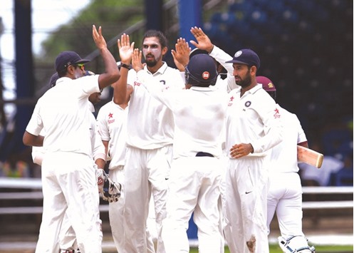 Indiau2019s Ishant Sharma (centre) celebrates the dismissal of Leon Johnson of West Indies on Day 1 of the fourth Test in Port of Spain, Trinidad, yesterday. (AFP)