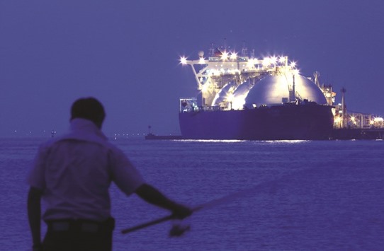 A man fishes in front an LNG tanker berthed at Tokyo Electric Power Cou2019s (Tepco) Futtsu gas-fired thermal power plant at night in Futtsu, Chiba Prefecture, Japan (file). The countryu2019s Fair Trade Commission is in the process of probing resale restrictions in longer deals in an effort that could mean the renegotiation of more than $600bn in contracts and boost the number of shorter-term agreements.