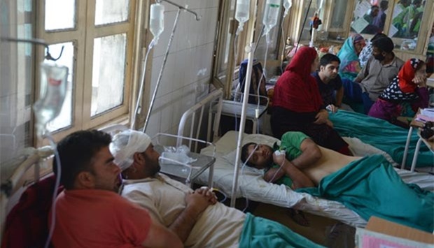 Injured Kashmiri patients, who were allegedly beaten up by Indan army soldiers, are comforted by relatives while lying on hospital beds in Srinagar.