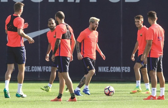 Barcelonau2019s Argentinian forward Lionel Messi dribbles the ball between teammates during a training session at the Sports Center FC Barcelona Joan Gamper in Sant Joan Despi, near Barcelona, yesterday.
