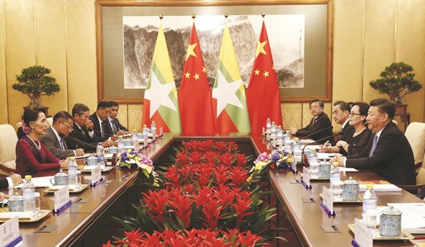 Suu Kyi and Xi Jinping lead their delegations in a meeting at the Diaoyutai State Guesthouse in Beijing yesterday.