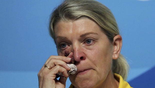 Kitty Chiller, Chef de Mission for Australia at the Rio 2016 Olympic Games, wipes her eyes during a press conference in which she spoke about the fines levied against a group of their athletes for entering the basketball arena without proper accreditation, in Rio de Janeiro August 20, 2016. Reuters
