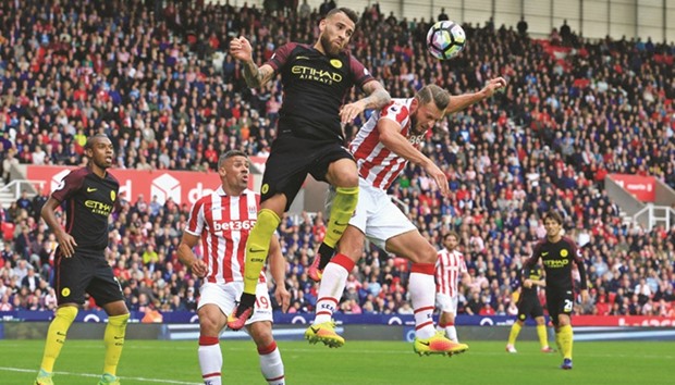 Stoke Cityu2019s Dutch defender Erik Pieters (centre right) vies with Manchester Cityu2019s Argentinian defender Nicolas Otamendi during their English Premier League match in Stoke-on-Trent, central England.