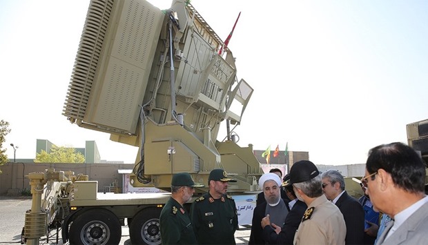 Iranian President Hassan Rouhani (3rd-R) and Iranian Defence Minister Hossein Dehghan (2nd-L) standing next to the new Bavar 373 missile defence system