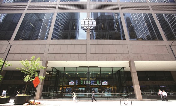 People walk past the front facade of CME Group headquarters in Chicago. To ramp up its recruiting efforts, CME will on September 9 open an office at the University of Illinois at Urbana-Champaignu2019s Research Park, a technology epicentre that already hosts 101 finance, technology and agriculture companies.