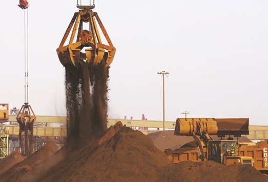 Cranes unload imported iron ore from a ship at a Chinese port. China accounts for about 65% of iron ore imports, takes 21% of seaborne metallurgical coal and consumes about half the worldu2019s copper.