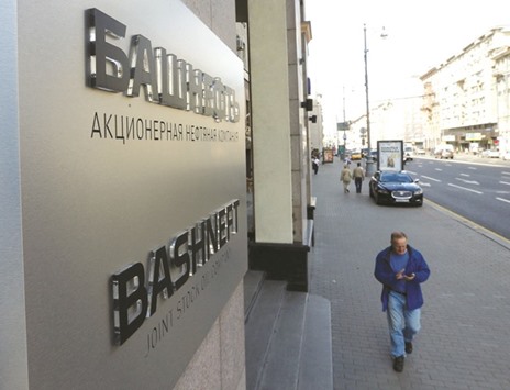 People walk past the headquarters of Bashneft in central Moscow. A power  struggle within President Vladimir Putinu2019s inner circle may lie behind Russiau2019s surprise decision to delay selling a stake in Bashneft, its biggest asset sale in a decade, according to analysts.