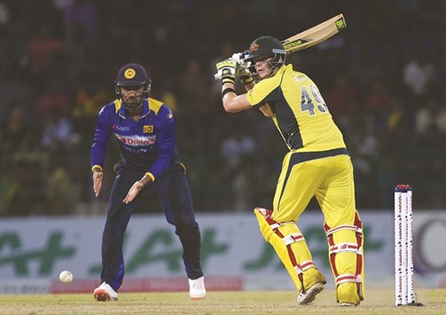 Australian cricket captain Steven Smith (R) plays a shot during the first One Day International (ODI) cricket match at the R Premadasa International Cricket Stadium in Colombo yesterday.