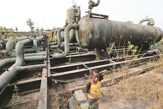 A boy plays near broken pipelines at an abandoned oil flow station operated by Royal Dutch Shell in K-Dare, Nigeria. In the six months since a major attack on Nigeriau2019s oil u2014 a sophisticated bombing of the subsea Forcados pipeline u2014 dozens of attacks have pushed production outages to more than 700,000 bpd, the highest in seven years.
