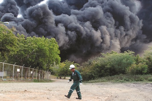 Thick smoke billows after an explosion at a fuel storage tank belonging to the Puma Energy company in Puerto Sandino, Leon, Nicaragua.