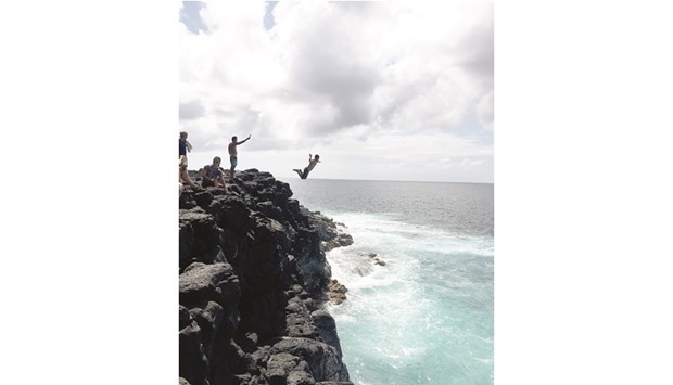 THE JUMP:  Ambrosio Avestruz takes the plunge from a large cliff at Queenu2019s Bath. Be warned: this can be a dangerous endeavour.