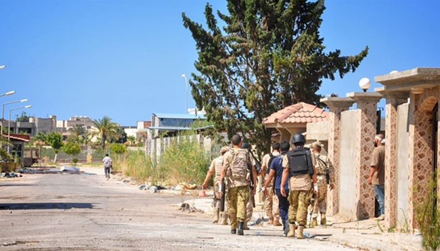 Members of forces loyal to Libya's unity government taking part in the military operations against the Islamic State group in Dollar neighborhood in the center of Sirte