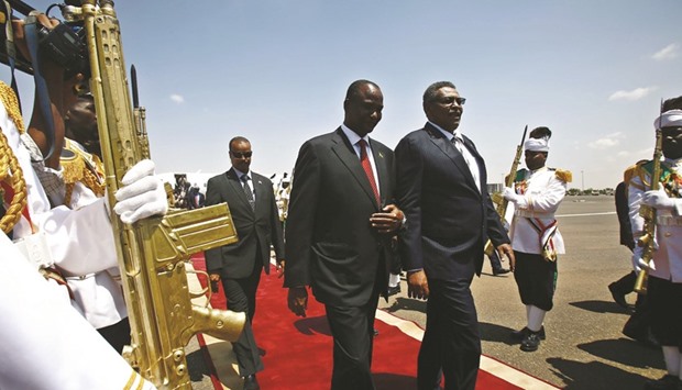 Sudanu2019s Vice President Bakri Hassan Saleh (centre right) and his South Sudan counterpart, Taban Deng Gai (centre left) review the honour guard upon his arrival at Khartoum airport yesterday for an official two-day visit.