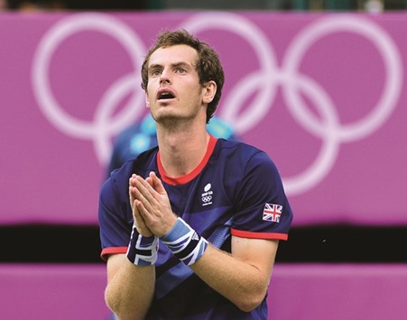 This file photo taken on August 05, 2012 shows Great Britainu2019s Andy Murray celebrating after winning the menu2019s singles gold medal match at the London 2012 Olympic Games by defeating Switzerlandu2019s Roger Federer.