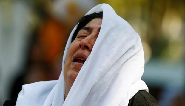 A woman mourns while waiting in front of a hospital morgue in the Turkish city of Gaziantep, after a suspected bomber targeted a wedding celebration in the city, Turkey, yesterday.