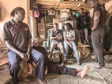 BRIEFING: Wakaliwood actors listen as Isaac Nabwana, the head of Wakaliwood studios, briefs them ahead of shooting a scene in his latest movie.