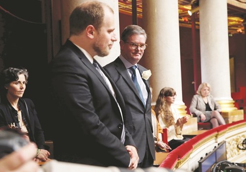 This file photo taken on June 21 shows British ambassador to France Julian King (right) holding, along with French deputies and government members, a moment of silence for slain British Labour party MP Joe Cox during the questions to the government session at the French National Assembly in Paris.