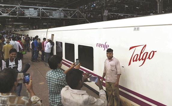 Media representatives take pictures of train coaches from Spanish manufacturer Talgo after their arrival at Mumbai Central train terminal.