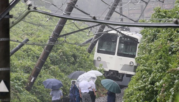 a derailed train in a landslide on the Seibu Tamako line in Higashimurayama, western Tokyo