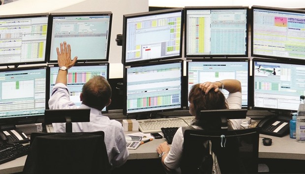 Traders work at the  Frankfurt Stock Exchange. The DAX 30 closed down 0.5% to 10,494.35 points yesterday.