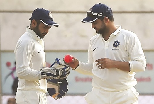 India Green captain Suresh Raina (right) and wicketkeeper Parthiv Patel have a look at the pink ball during the flood-lit Duleep Trophy match against India Red yesterday. (AFP)