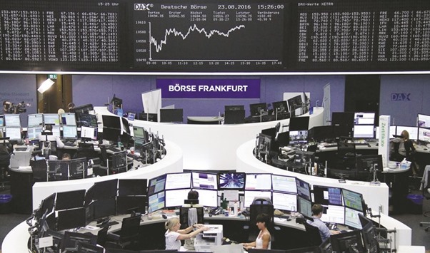 Traders work at the Frankfurt Stock Exchange. The DAX 30 closed up 1.0% to 10,592.9 points yesterday.