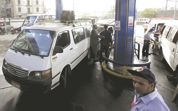 Vehicles are seen in a queue at a petrol station in Cairo. Egypt plans to end fuel subsidies within three years and is aiming to increase fuel prices to 65% of their actual cost during the 2016/17 fiscal year.