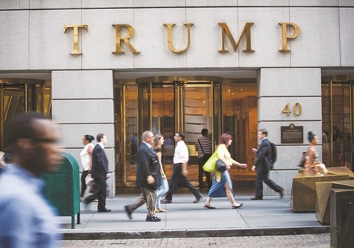 Pedestrians walk past the Trump building in New York. Of all of Donald Trumpu2019s ventures outside his core real estate business, it is mortgage business, perhaps more than any other, that clashes with the image of financial guru that heu2019s cultivated on the presidential campaign trail.