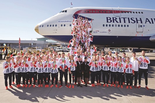 Members of the British Olympic team pose with their medals after returning from the Rio Games on a gold-tipped Boeing 747 at Heathrow airport in London yesterday. (AFP)