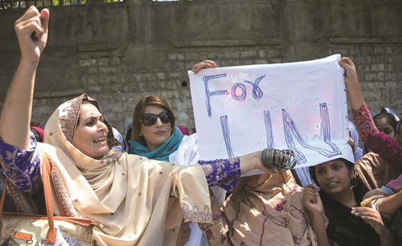 A Pakistani Kashmiri shouts slogan as she holds bangles during a protest with others in Muzaffarabad, the capital of Pakistan-administered Kashmir. Women in Pakistan-administered Kashmir offered their bangles to Ban Ki-moon, an insult in patriarchal South Asia aimed at the UN headu2019s perceived inaction over violence on the Indian side of the disputed region.