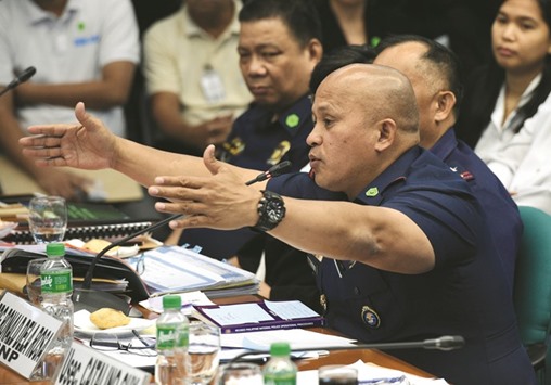 Philippine national police director general Ronald Dela Rosa gestures as he speaks during the second-day of the senate hearing in Manila  yesterday, on the spate of extra judicial killings in a war on crime.