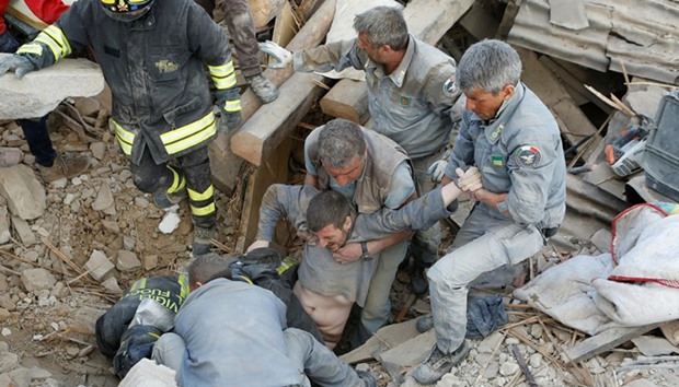 A man is rescued alive from the ruins following an earthquake in Amatrice, central Italy