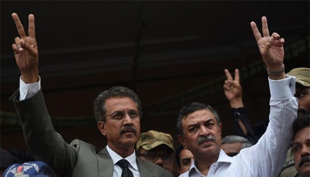 Newly elected mayor of Karachi Waseem Akhtar (left) and his deputy Arshad Vohra flash victory signs after winning the mayoral election in Karachi on Wednesday.
