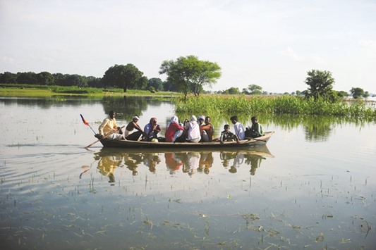 Villagers being transported by boat to to drier ground after their houses were submerged by floodwaters from the River Ganga at Mubarakpur on the outskirts of Allahabad.